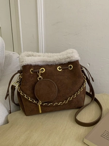 Brown frosted suede bucket bag with white faux fur trim and gold chain detail