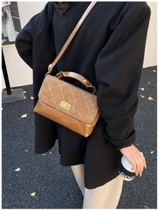 Detail of vintage brown crossbody bag featuring contrast textures and diamond stitching