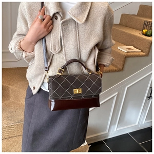 Detail of vintage colorblock quilted crossbody bag with gold-tone metal twist lock