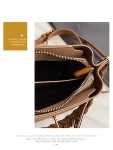 Close-up of smooth metal zipper and internal double compartments of the bucket bag