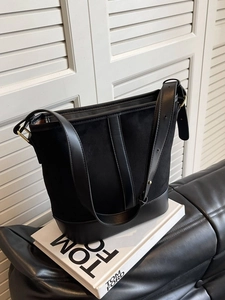 Classic black suede bucket bag with adjustable leather strap for stylish daily commuting