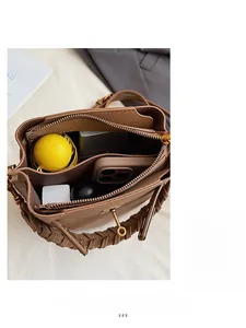 Internal view of the brown bucket bag showing large capacity for daily essentials