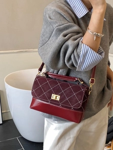 Burgundy quilted crossbody bag with gold twist lock and adjustable shoulder strap