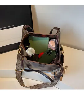 Top view showing large capacity interior of dark brown leather tote bag with daily items