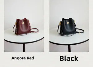 Detail view of lychee pattern leather bucket bags in Anchora Red and classic black