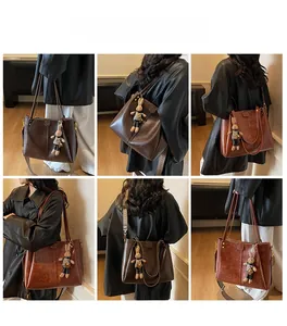 Multi-angle view of vintage tote bag with geometric wide strap and plush bunny charm