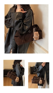 Detail of vintage oil wax leather tote bag with plush bear charm and spacious structure