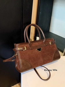 Retro dark brown crossbody bag with matte suede texture and metal triangle logo plaque