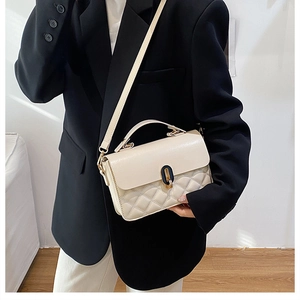 Quilted cream leather crossbody bag styled on a black oversized blazer for daily commute