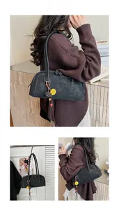 Detail of vintage Boston bag featuring ethnic tassel charm and matte suede finish