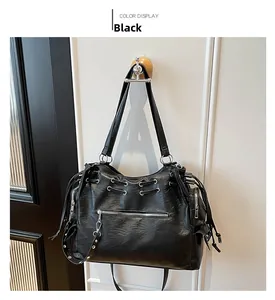 Detail of black large tote bag with vintage oil-wax PU texture and silver zipper pocket