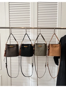 Detail of vintage matte suede bucket bags in four colors with Kelly-style metal buckles