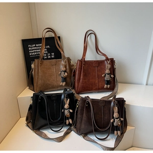 Four vintage faux leather tote bags in various colors with jacquard wide straps and bunny charms