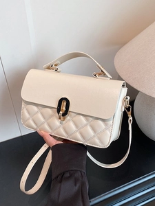 Elegant cream quilted handbag with diamond stitching and gold-tone turn-lock buckle