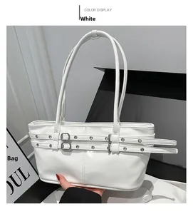Detailed close-up of a white patent leather shoulder bag with decorative buckle straps