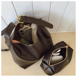 Detail view of large dark brown leather tote bag interior with matching zipper pouch