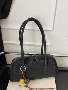 Retro black Boston shoulder bag with contrast stitching and fuzzy pompom accessory