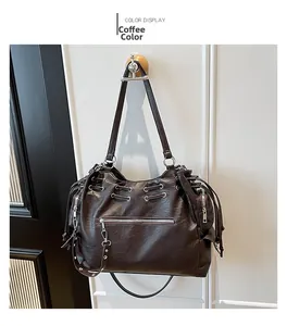 Detailed view of coffee brown tote bag featuring textured leather and side drawstring detail