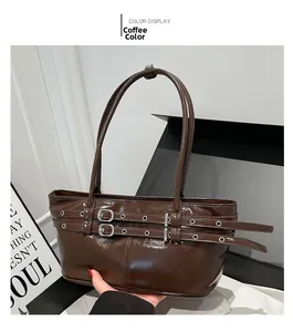 Detail of coffee brown glossy patent leather shoulder bag with decorative buckles