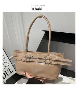 Detailed shot of khaki glossy leather tote bag with metal buckles and slim handle straps