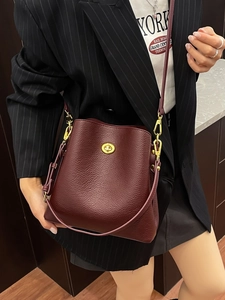 Burgundy lychee grain leather bucket bag with gold lock and adjustable strap