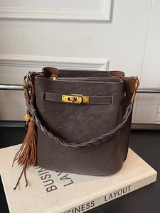 Vintage frosted coffee bucket bag with woven handle, metal lock, and stylish tassel accent