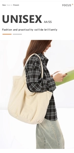 Detail view of large cream canvas tote bag showing washed texture and sturdy shoulder strap