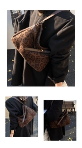 Detail of leopard print hobo bag with dark brown leather straps and gold metal buckles