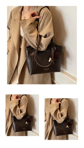 Close-up of dark brown stone pattern tote bag with vintage texture and golden branding
