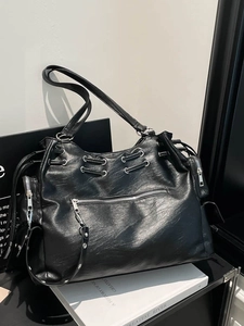 Vintage large black leather tote bag with silver eyelets and multiple zippers for women