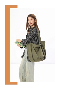 Close-up of olive green oversized canvas tote bag with thick texture and wide shoulder strap
