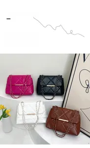 Quilted chain bags in four colors arranged on a white tiered stand with gold hardware