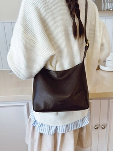 Minimalist dark brown leather crescent hobo bag for women with sleek shoulder strap