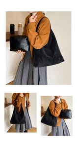 Detail shot of black leather tote bag set including a large shoulder bag and small pouch