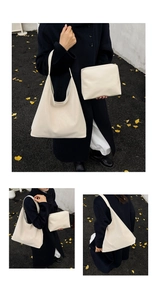 Detail of cream white leather hobo tote bag set with matching inner pouch on a street background