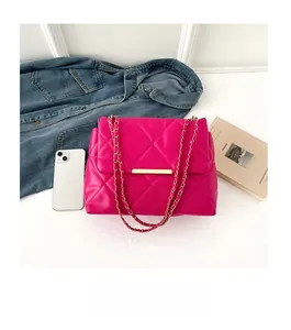 Detailed comparison of the magenta quilted chain bag size next to a smartphone