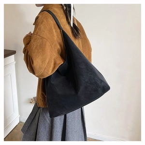 Suede Hobo shoulder bag worn by model showing its large capacity and minimalist design