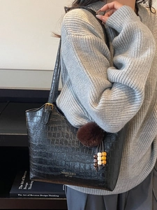 Vintage black crocodile pattern tote bag with plush charm and adjustable strap for women