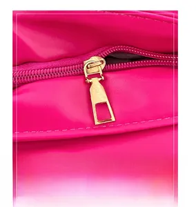 Macro detail of high-quality golden metal zipper and stitching on hot pink quilted bag