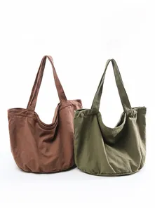 Brown and olive washed canvas tote bags showing spacious U-shaped design and wide straps