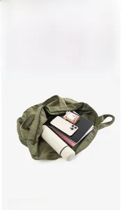 Internal view of army green canvas tote bag showing large capacity for gadgets