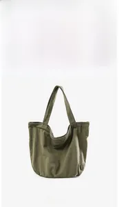 Front view showing the silhouette and handles of the washed army green canvas tote bag