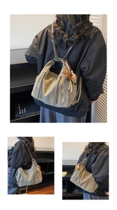 Detail view of khaki faux leather backpack with star and bear charm on minimalist shelf
