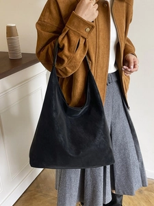 Minimalist black matte suede large tote bag styled as a shoulder hobo bag for women