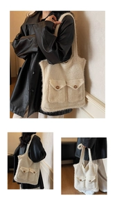 Detail of knit shoulder tote bag with front flap pockets and brown button accents