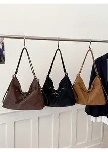Hanging display of woven leather tote bags in brown, black, and camel color options
