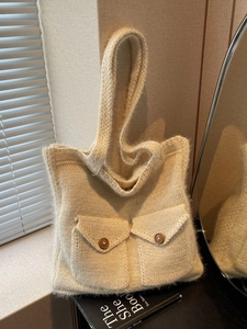 Large beige crochet tote bag with wooden button pockets and long shoulder straps