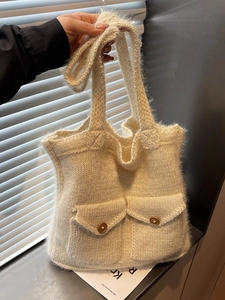 Large cream knit plush tote bag with functional brown button pockets and long shoulder strap