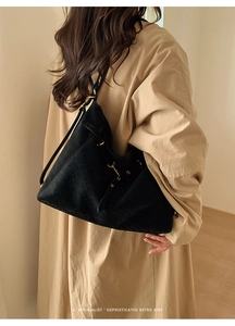 Detail of black woven leather texture on a large hobo shoulder bag for women