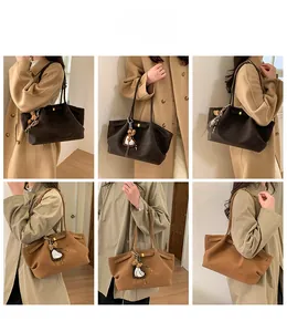 Detailed views of minimalist suede tote bags in brown and beige with leopard heart charm